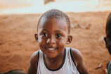 Close-up of a child in the space design t-shirt, smiling with natural skin tones and sharp focus.