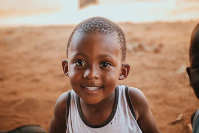 Close-up of a child in the space design t-shirt, smiling with natural skin tones and sharp focus.