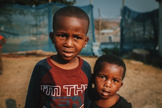 two young boys standing next to each other