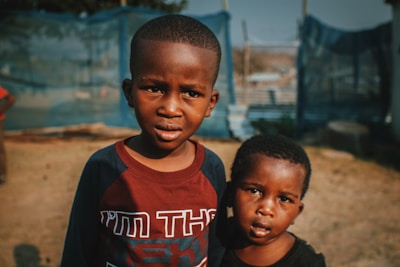 two young boys standing next to each other