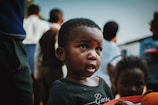 Close-up of a young child holding a meal box with gratitude and hope in their eyes.