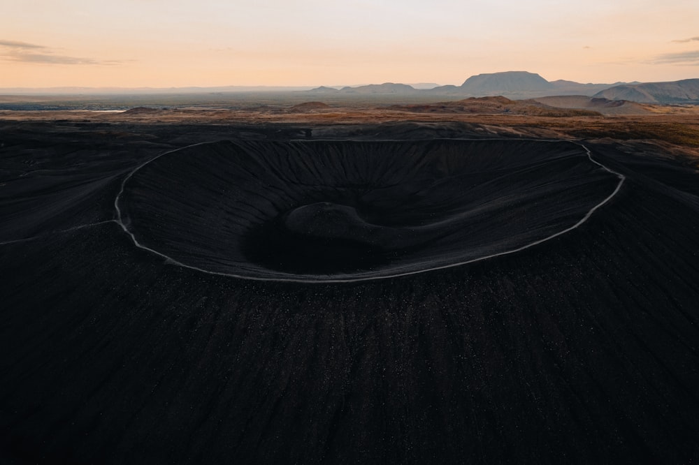 a large crater in the middle of a desert