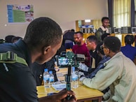Workshop setting with participants learning about marine environment monitoring using cameras.