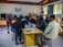 A diverse group of students collaborating on a science project in a bright classroom.