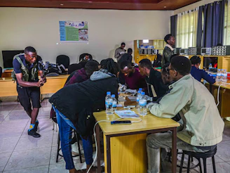 A diverse team collaborating around a table illuminated by warm natural light.