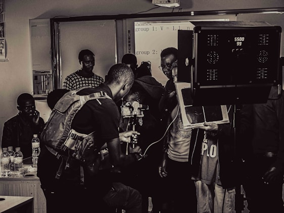 Photo of a creative team collaborating on a video production set with cameras and lighting equipment.