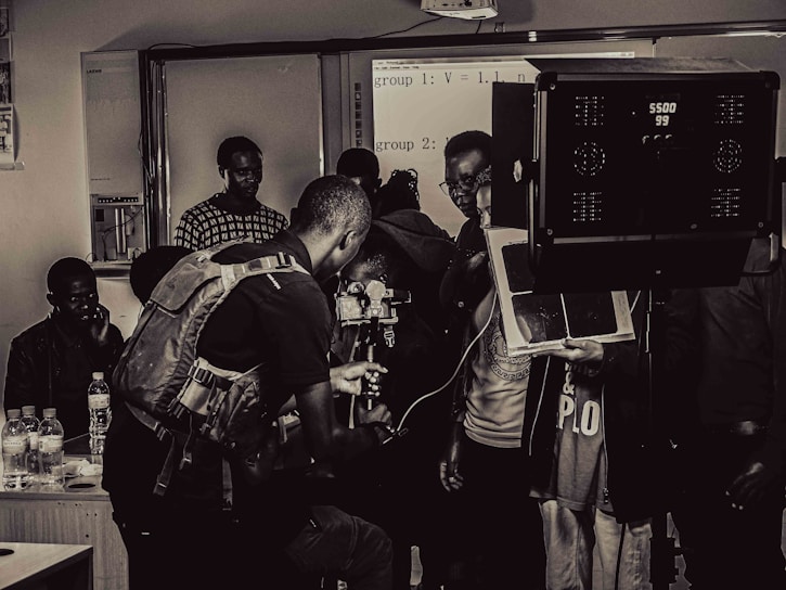 A behind-the-scenes photo of a film crew setting up cameras and lighting equipment on location.