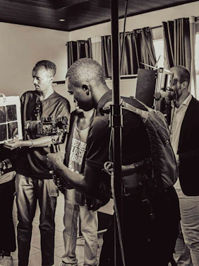 A group of journalists engaged in a certification workshop with laptops and cameras.