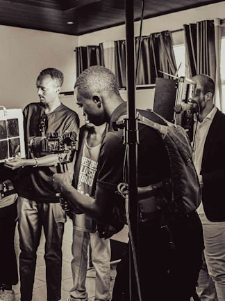 Behind the scenes of a content creation session, with laptops, cameras, and focused team members planning.