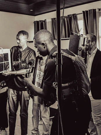 A vibrant workshop scene where young creators are gathered around cameras and editing equipment, deeply engaged in storytelling.