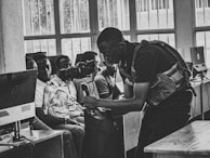 A mentor demonstrating a software tool to a small group.