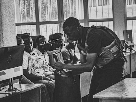 A trainer instructing employees on operating technical equipment.