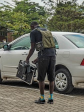 Smiling Knoxville Jumpstart technician standing beside a black truck ready to assist.