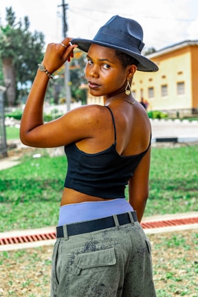 Model posing outdoors in classic cargo pants with gold-accented accessories.