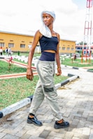 A woman walking outdoors in casual clothes, confidently wearing the posture device.