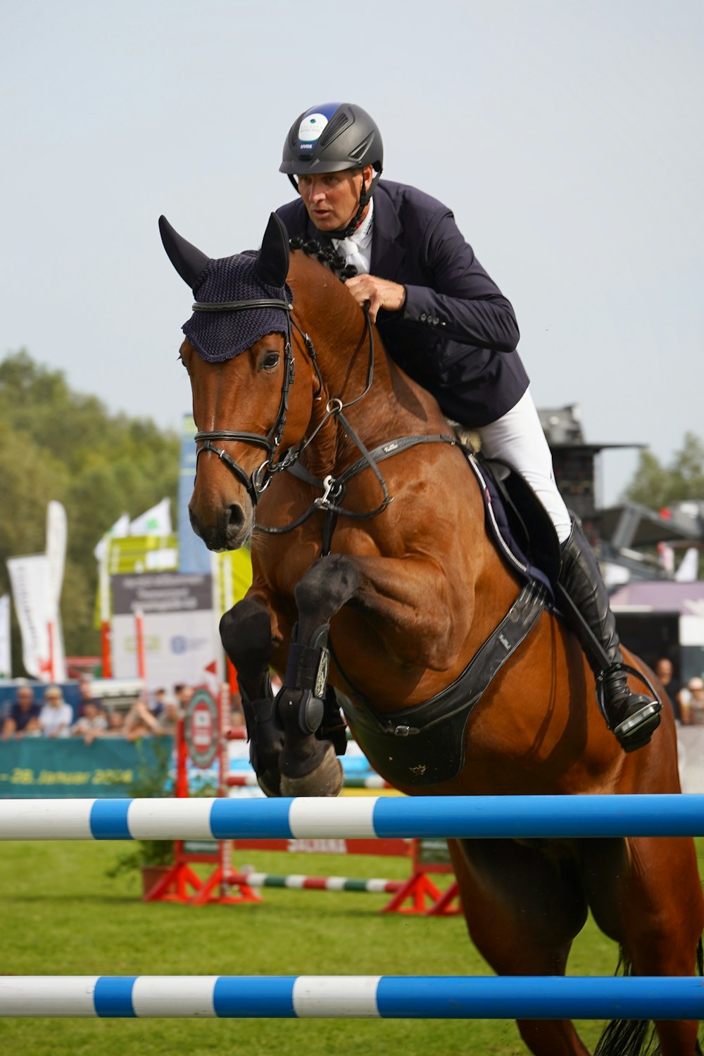 a man riding on the back of a brown horse