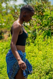A model wearing a flowy skirt and tank top outdoors.