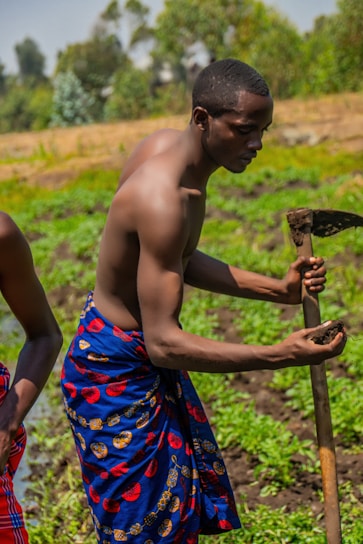 A professional agronomist examining high-quality agricultural tools in a lush green field.