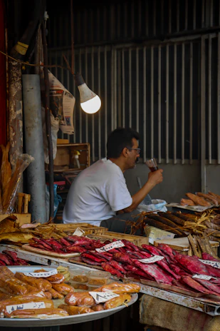 Selection of Rūkykla Plus products including smoked fish, craft beer, and local delicacies displayed on a market stall.