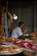 Close-up of a happy customer enjoying dried fish snacks with a cold beer.