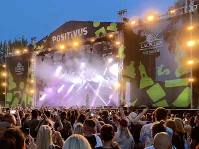 A lively crowd laughing under colorful stage lights at a Pussy Jam Comedy show in Tallinn.