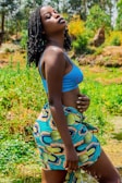 A vibrant outdoor scene featuring a woman with knotless braids.