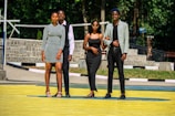 A group of diverse young adults wearing stylish outfits outdoors.