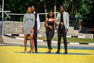 Young adults wearing casual sporty clothing in a bright urban setting.