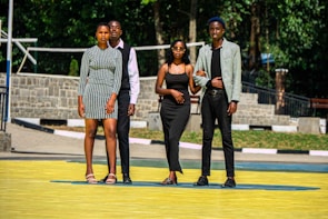 A group of diverse young adults wearing stylish outfits outdoors.