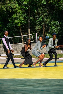 A vibrant photo of a diverse group of pickleball players laughing and enjoying a sunny game together.
