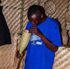 Professional in blue uniform inspecting a modern Belgian home with a clipboard.