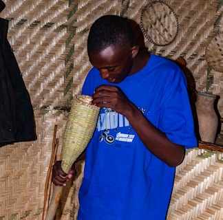 A worker inspecting the quality of a bright red plastic basket.