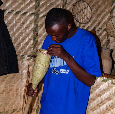 Professional in blue uniform inspecting a modern Belgian home with a clipboard.