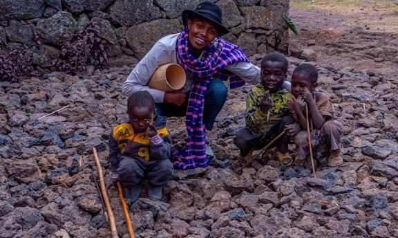 A warm moment of a volunteer helping children in an African village.