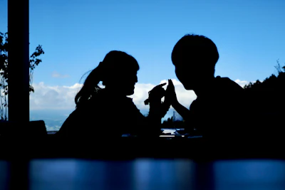 A partner handshake silhouetted against a backdrop of soaring airplanes.