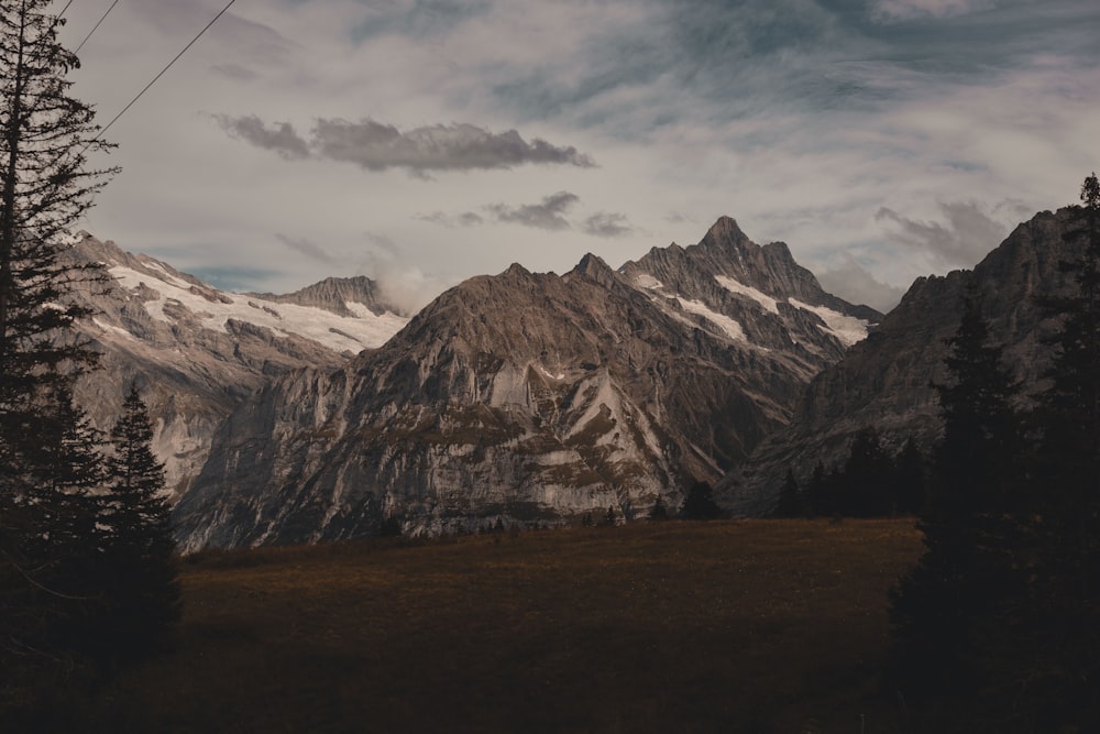 a view of a mountain range with a telephone pole in the foreground