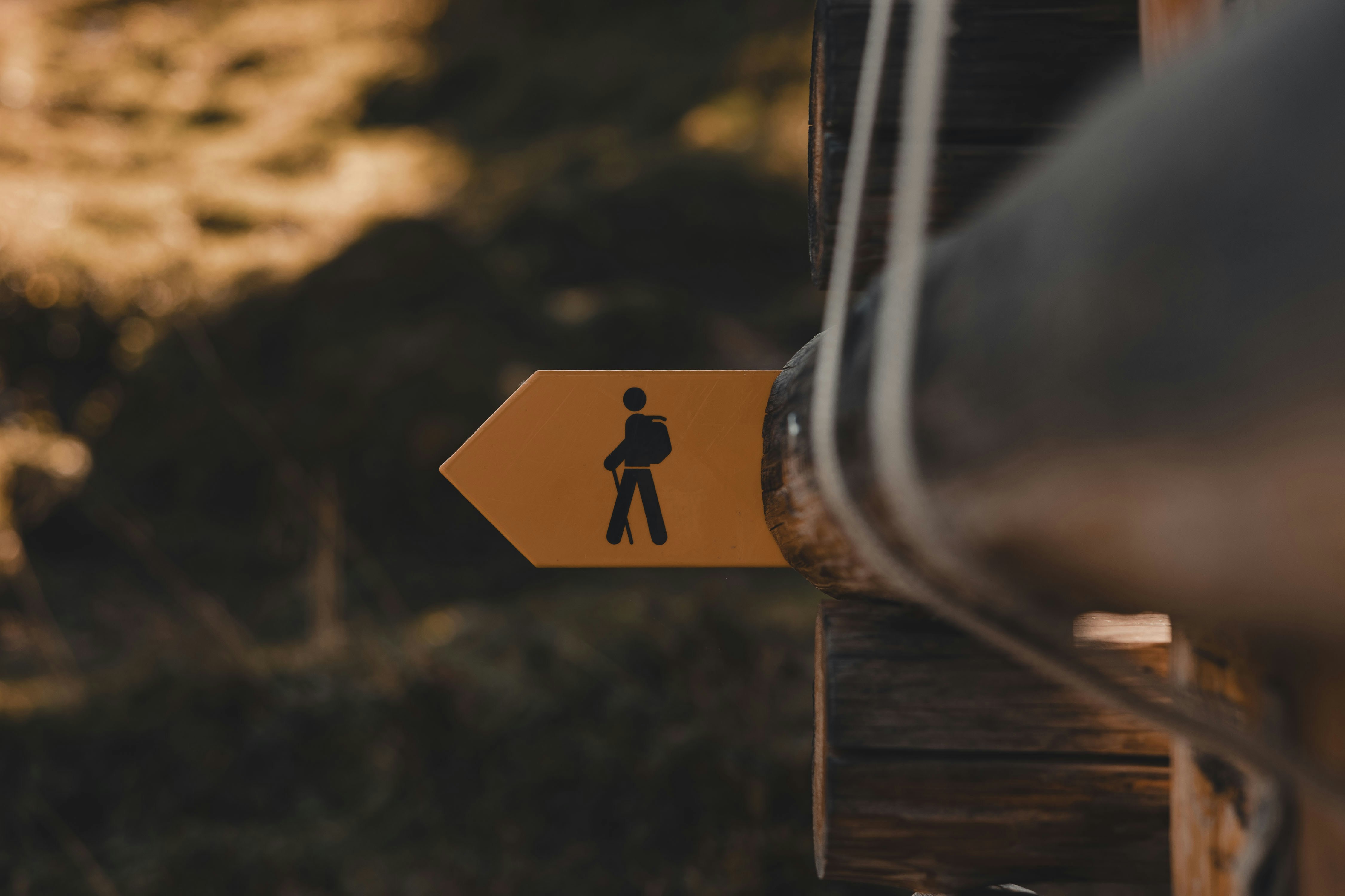 a yellow sign with a man walking on it