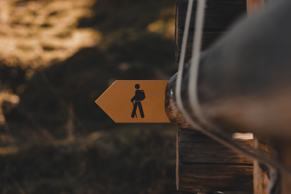 a yellow sign with a man walking on it