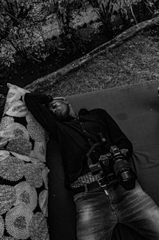 A traveler enjoying a peaceful moment outdoors with a travel pillow and wellness kit.