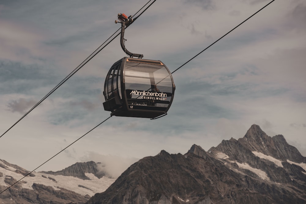 a cable car with a mountain in the background
