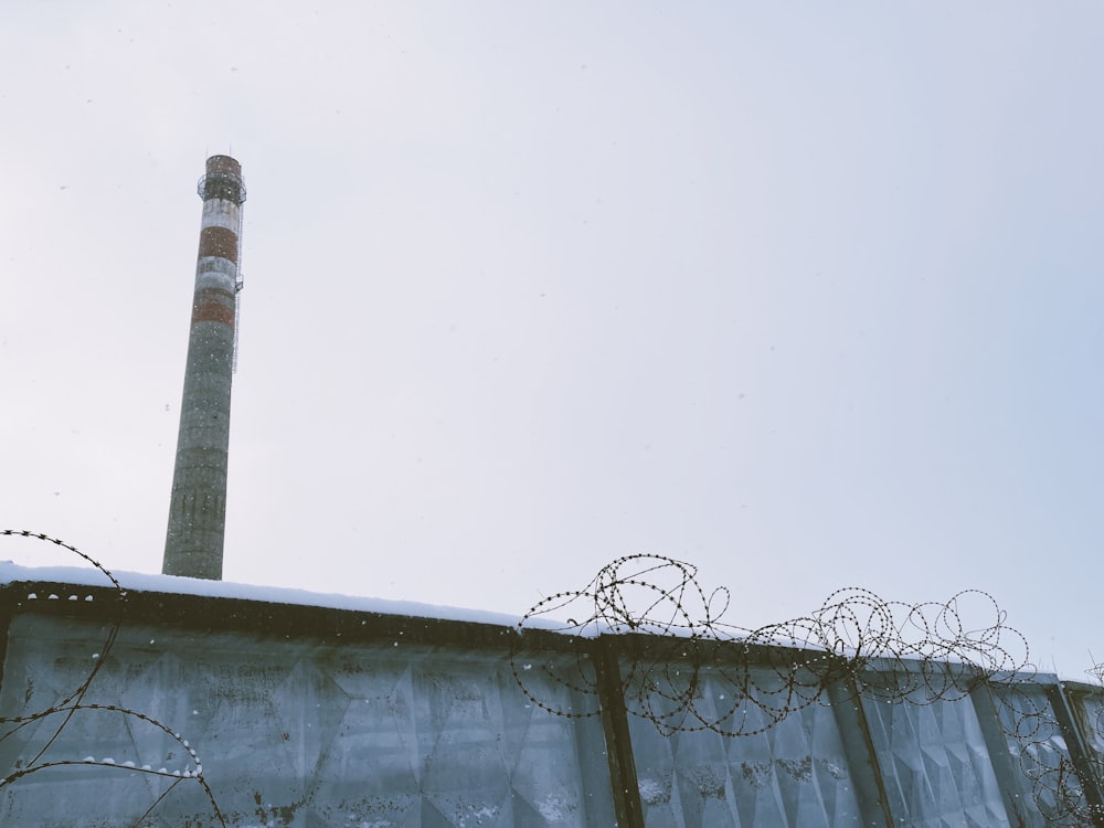 a tall building with barbed wire on top of it