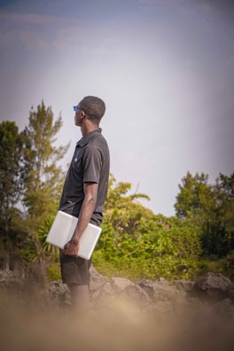 Field technician assisting a client with laptop troubleshooting outdoors.