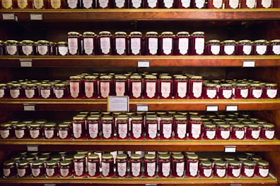 Colorful jars of homemade doce de leite and other traditional sweets.