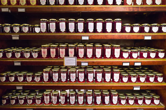 Brightly packaged jars of instant baby food arranged on a clean factory shelf.