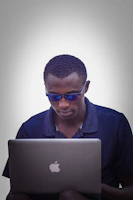 A focused person working on a laptop with a calm blue background symbolizing productivity