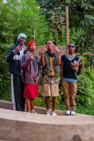 A group of friends laughing outdoors, all dressed in casual men's clothing from vesteviva.