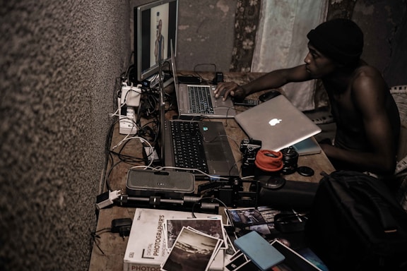 Photo of the founder working at a desk surrounded by computer parts and CCTV cameras.