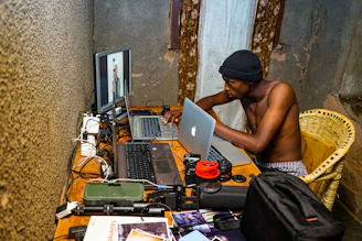 Portrait of Marek Gellermann working focused at his laptop in a modern, minimalistic workspace.