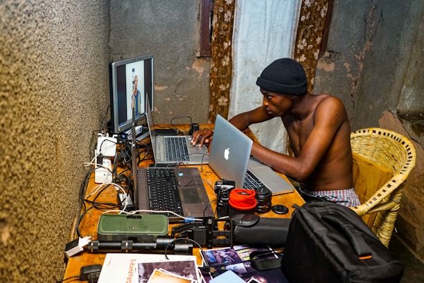 A candid photo of Muhammad Alam working intently at his computer desk.