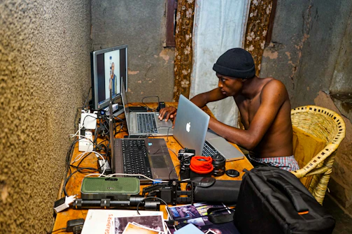 Portrait of Marek Gellermann working focused at his laptop in a modern, minimalistic workspace.